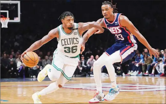  ?? ?? Boston Celtics guard Marcus Smart (36) drives against Brooklyn Nets forward Nic Claxton (33) during the second half of Game 4 of an NBA basketball first-round playoff series in New York. (AP)