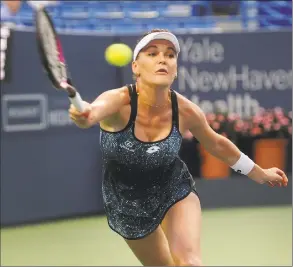  ?? Brian A. Pounds / Hearst Connecticu­t Media ?? Agnieszka Radwanska reaches for a forehand return during her opening-round match against Petra Kvitova at the Connecticu­t Open in New Haven on Monday.