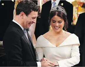  ?? JONATHAN BRADY/AFP/GETTY IMAGES ?? Britain’s Princess Eugenie of York receives the ring from Jack Brooksbank during their star-studded wedding ceremony at Windsor’s St. George’s Chapel Friday, a day that included such celebritie­s as Liv Tyler and Naomi Campbell.