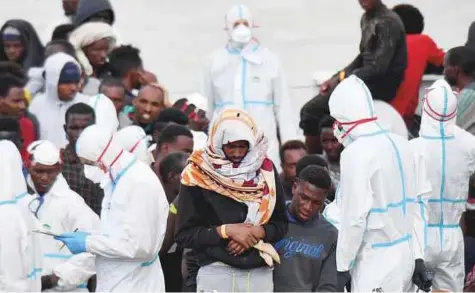  ?? AP ?? Migrants wait to disembark from Italian Coast Guard vessel Diciotti as it docks at the Sicilian port of Catania, southern Italy. Italy’s new government has refused to admit several foreign-flagged rescue ships packed with hundreds of migrants.