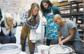  ?? Paul Chinn / The Chronicle ?? Cindy Lyssikatos (left), Peir Serota and Puya Vakili watch master potter Eric Landon, co-founder of the Tortus Copenhagen ceramics studio, at a pottery workshop in S.F.