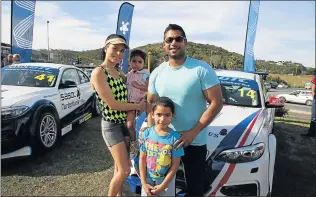  ??  ?? CHARMED BY WHEELS: Mark and Jackoleen Raphael pose for a picture with young Hope and Zachariah at the Sasol GTC activation over the weekend