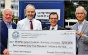 ?? DAVID ANDERSEN ?? Dunwoody Champions Golf Associatio­n presents a check for $265,000 to Emory’s Winship Cancer Institute for prostate cancer research.