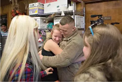  ?? Staff photo by Evan Lewis ?? Air Force Airman 1st Class Sawyer Spaulding hugs his little sister, Hartley, Thursday morning at Texas High School. Sawyer has been deployed for two years and surprised Hartley and their other sister, Piper, who didn’t know he would be home for...