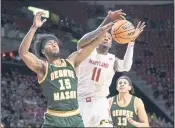  ?? NICK WASS – THE ASSOCIATED PRESS ?? George Mason guard D’Shawn Schwartz, left, and Maryland guard Xavier Green battle for a rebound on Wednesday.