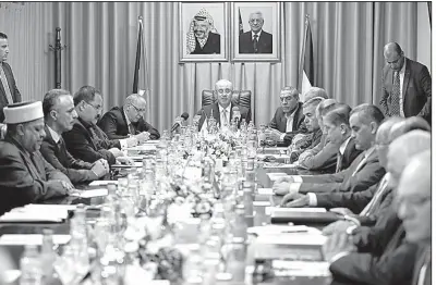  ?? AP/MOHAMMED ABED ?? Palestinia­n Prime Minister Rami Hamdallah (center) chairs a reconcilia­tion government Cabinet meeting Tuesday in Gaza.