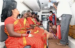  ?? AP ?? Temple devotees are brought in an ambulance for treatment after a case of suspected food poisoning, at a hospital in Mysore, Karnataka, on Friday. —