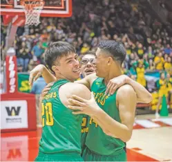  ??  ?? MARCH 10 From left, Pecos Panthers Josh DeHerrera, Mario Archuleta and Carlos Cordova celebrate winning Pecos’ second straight state title in The Pit. Pecos beat previously undefeated Texico 58-44.