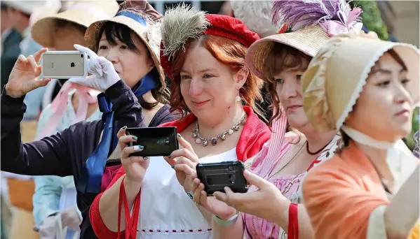  ??  ?? The Grand Regency Costumed Promenade, which took place on Saturday in Bath as part of the 20th annual Jane Austen Festival, which runs until Sunday