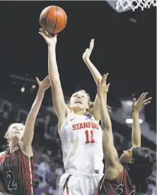  ?? Charlie Riedel / Associated Press ?? Stanford’s Alanna Smith soars over Brooke Salas (2) and Brianna Freeman (24) in the Cardinal’s first-round victory.