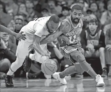  ?? CHUCK BURTON/AP PHOTO ?? Charlotte’s Kemba Walker, left, and Boston’s Kyrie Irving battle for a loose ball during the Celtics’ 102-91 win over the Hornets on Wednesday in Charlotte, N.C.