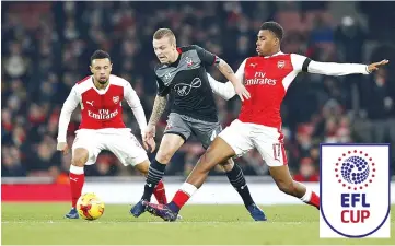  ??  ?? Southampto­n’s Dutch midfielder Jordy Clasie (C) vies with Arsenal’s French midfielder Francis Coquelin (L) and Arsenal’s Nigerian striker Alex Iwobi during the EFL (English Football League) Cup quarter-final football match between Arsenal and...