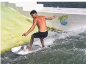  ??  ?? Luis van Well surft auf der künstlich stehenden Welle im See.