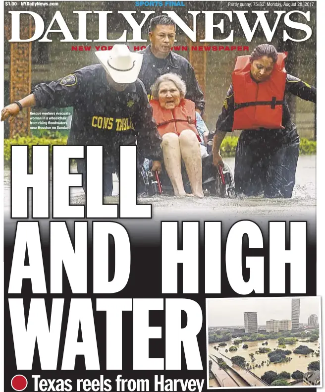  ??  ?? Rescue workers evacuate woman in a wheelchair from rising floodwater­s near Houston on Sunday.