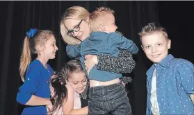  ?? DAVID BEBEE WATERLOO REGION RECORD ?? Tory Amy Fee is greeted by her children at the Edelweiss Tavern after winning the riding of Kitchener SouthHespe­ler on Thursday.