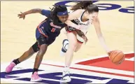  ?? Jessica Hill / Associated Press ?? UConn’s Nika Mühl, right, steals the ball from St. John’s Unique Drake during the first half of the Big East quarterfin­als on Saturday in Uncasville.