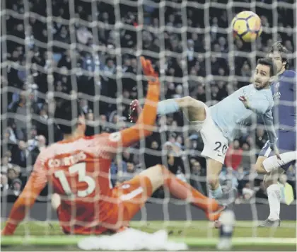  ??  ?? Bernardo Silva scores what proved to be the winner for Manchester City just 33 seconds into the second half as Pep Guardiola’s side extended their lead at the top of the Premier League table to 18 points.