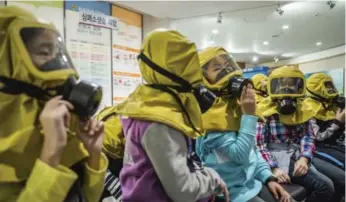  ?? LAM YIK FEI/THE NEW YORK TIMES ?? Students in Seoul, South Korea, learn to use gas masks in case of chemical or biological attacks.