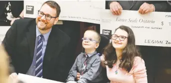  ?? NICK BRANCACCIO ?? Easter Seals telethon host Mark Mckenzie poses with 2020 Windsor-essex regional ambassador­s Alex Bondy and Brigid Kidd on Wednesday during a kickoff event at Caboto Club in Windsor.