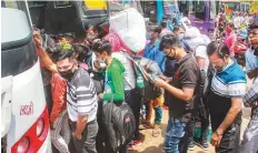  ?? PTI ?? ■ Migrants board interstate buses, amid the rise in Covid-19 cases in NCR region, in Gurugram, yesterday.