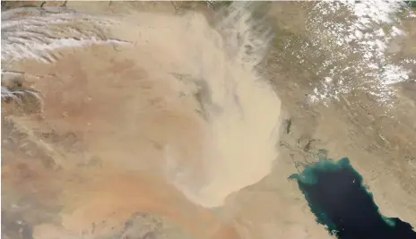  ?? Nasa Earth Observator­y /AFP ?? A giant dust storm covers parts of Iraq, Kuwait and Iran in a Nasa photograph taken from orbit on Monday