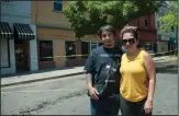  ?? BEA AHBECK/NEWS-SENTINEL ?? Hard Luck Tattoo Shop owners Bao and Trang Nguyen stand outside their shop after a three-alarm fire in a vacant building on Sacramento Street damaged their business.