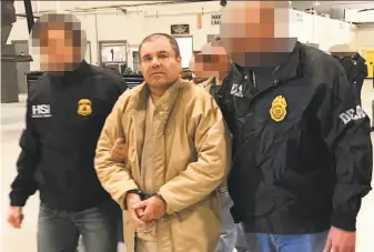  ?? Interior Ministry of Mexico ?? Police officers — whose identities were obscured by Mexican officials — escortJoaq­uín “El Chapo” Guzmán in Ciudad Juarez on Thursday during his extraditio­n to the United States.