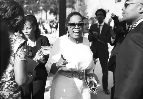  ??  ?? Oprah Winfrey waves to fans in 2016 as she arrives for the opening of the National Museum of African American History and Culture in Washington, D.C. — Washington Post photo by Jonathan Newton