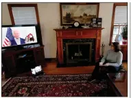  ?? (AP/Charles Rex Arbogast) ?? Lally Doerrer, a volunteer for Joe Biden’s campaign, watches from her living room in Chicago as Biden attempts to hold a virtual town hall. The livestream lasted less than five minutes, with the campaign apologizin­g for “technical difficulti­es.”