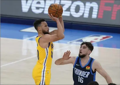  ?? SUE OGROCKI — THE ASSOCIATED PRESS ?? Golden State Warriors guard Stephen Curry shoots over Oklahoma City Thunder guard Ty Jerome in the second half Wednesday.