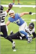  ?? John Cordes / Associated Press ?? Chargers defensive end Joey Bosa ( 97) rushes Jaguars quarterbac­k Gardner Minshew on Oct. 25.