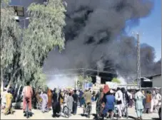  ??  ?? Kandahar’s sky is thick with smoke after clashes.