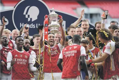  ?? Picture: AFP ?? ELATED. Arsenal’s Pierre-Emerick Aubameyang holds the FA Cup trophy aloft after they beat Chelsea 2-1 in the final at Wembley on Saturday.