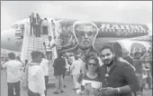  ?? PROVIDED TO CHINA DAILY ?? Fans of Rajinikant­h pose in front of a re-branded aircraft of AirAsia before boarding for a special flight to watch his new movie Kabali in Chennai, India.