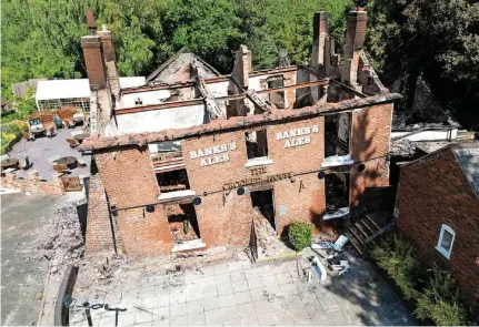  ?? ?? The burnt out remains of The Crooked House pub near Dudley before it was illegally demolished