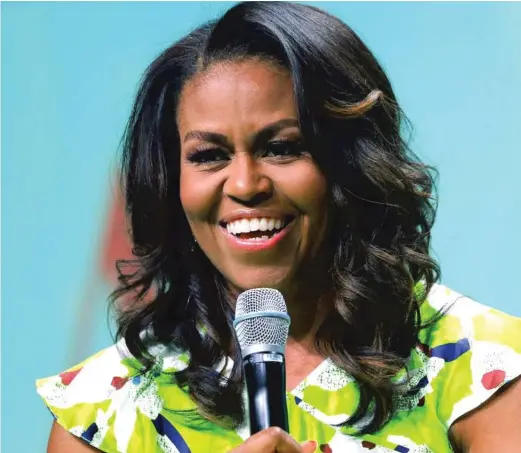  ?? GERALD HERBERT/AP FILE PHOTO ?? Former first lady Michelle Obama talks about growing up on the South Side in her new memoir.