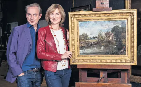  ??  ?? Fake or Fortune? presenters Philip Mould and Fiona Bruce with the painting now attributed to John Constable