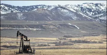  ?? NICK COTE / THE NEW YORK TIMES ?? An oil pump keeps pumping on the outskirts of Glenrock, Wyo. Tumbling oil and gas prices and bankruptci­es in the coal industry have pummeled Wyoming’s energydepe­ndent economy and unraveled a thin safety net.