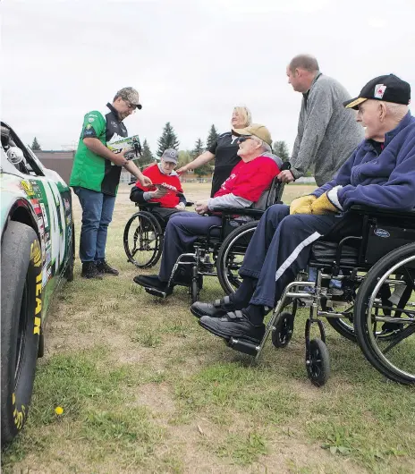  ?? KAYLE NEIS ?? Veterans and residents of Sherbrooke retirement home wait for the Skyhawks, the Canadian Armed Forces parachute team to land in Gerhard Herzberg Park in Saskatoon on Tuesday. However, the jump was cancelled as a result of heavy cloud cover. The tandem...