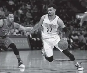  ?? John Leyba, The Denver Post ?? Nuggets guard Jamal Murray drives on Dallas Mavericks guard Devin Harris this season.