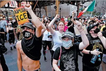  ?? CHRIS SWEDA/CHICAGO TRIBUNE ?? Protesters calling for the defunding of the Chicago Police Department, among other issues, march downtown Saturday.