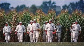  ?? CHARLIE NEIBERGALL / AP ?? People portraying ghost players emerge from a cornfield as they re-enact a scene from the movie “Field of Dreams” at the movie site in Dyersville, Iowa. The Chicago White Sox will play a game against the New York Yankees next August at the site in Iowa where the movie “Field of Dreams” was filmed.