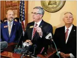  ?? BOB ANDRES / BANDRES@ AJC.COM ?? Rep. Barry Fleming (from left), Secretary of State Brad Raffensper­ger and Speaker David Ralston speak after the House OK’d a new system Tuesday.