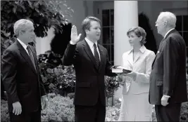  ?? ASSOCIATED PRESS ?? IN THIS JUNE 1, 2006, FILE PHOTO (FROM LEFT TO RIGHT) President Bush, watches the swearing-in of Brett Kavanaugh as Judge for the U.S. Court of Appeals for the District of Columbia by U.S. Supreme Court Associate Justice Anthony M. Kennedy (far right)during a ceremony in the Rose Garden of the White House, in Washington. Holding the Bible is Kavanaugh’s wife Ashley Kavanaugh.