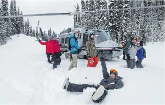  ??  ?? Heli-skiers and guides prepare to board their chopper for another trip up the mountain with Selkirk Tangiers near Revelstoke.