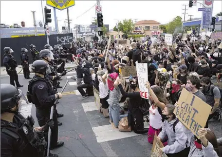  ?? Kent Nishimura Los Angeles Times ?? PROTESTERS attend a rally in Pan Pacific Park on May 30, 2020, against police brutality and the killing of George Floyd in Minneapoli­s.