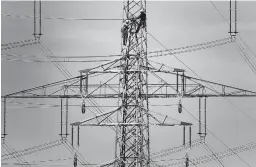  ?? FRANK AUGSTEIN/AP 2011 ?? Prices for electricit­y and natural gas are surging in Europe. Above, workers of the German energy company RWE prepare power supply in Moers, Germany.