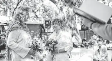  ?? STEVEN ST. JOHN, USA TODAY ?? Tanya Struble, 47, looks at Therese Councilor, 52, during their wedding. The Jemez Springs, N. M., couple, who have been together for 23 years, were married on Oct. 19.