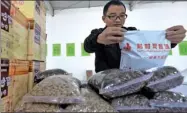  ?? HAO QUNYING / FOR CHINA DAILY ?? A worker packages rural products that have been ordered online in Guantao, Hebei province, in November.