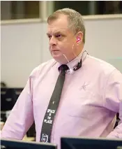  ?? Jon Shapley/Houston Chronicle via AP ?? Timothy “T.J.” Creamer, right, a former astronaut and current mission control flight director at NASA, works in the mission control room April 27 at the Johnson Space Center in Houston.